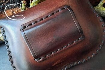 Leather lge pouch with scrath on reverse