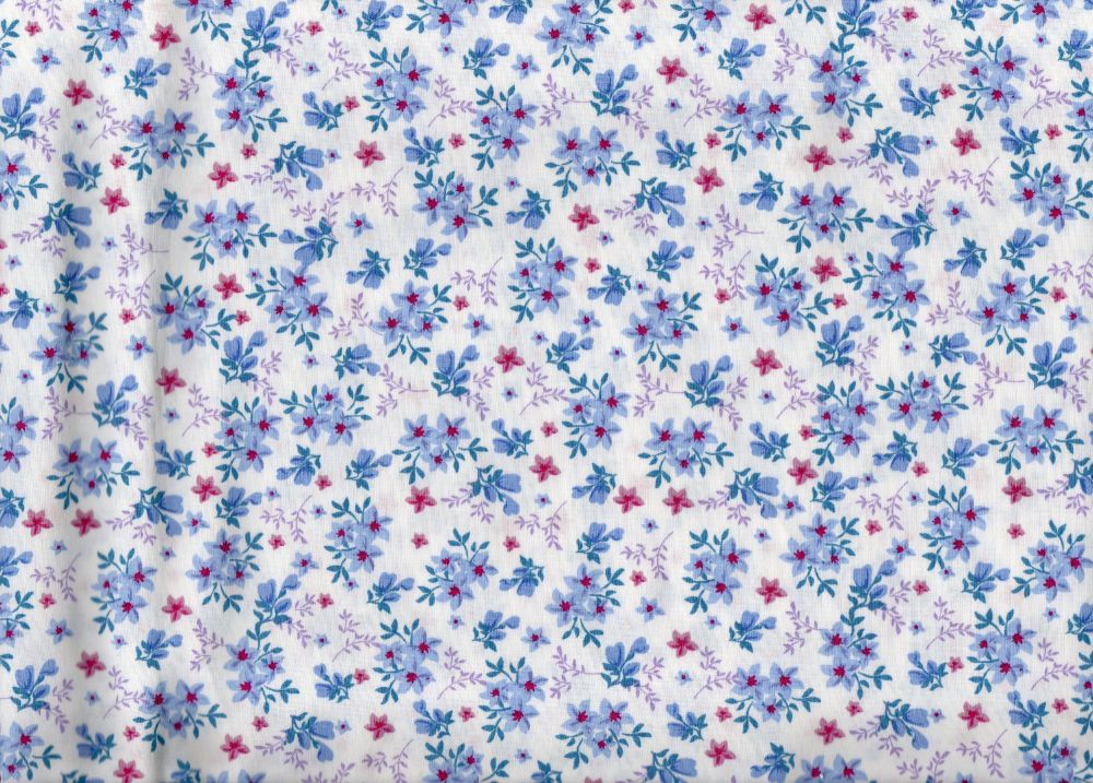 Floral ditsy fabric. White background with violet and pink flowers
