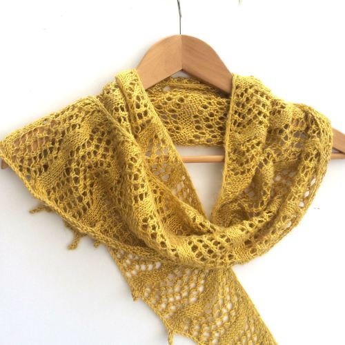 Yellow hand knitted crescent shaped shawl