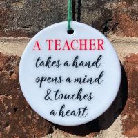 A teacher takes a hand, opens a mind and touches a heart hanging ornament