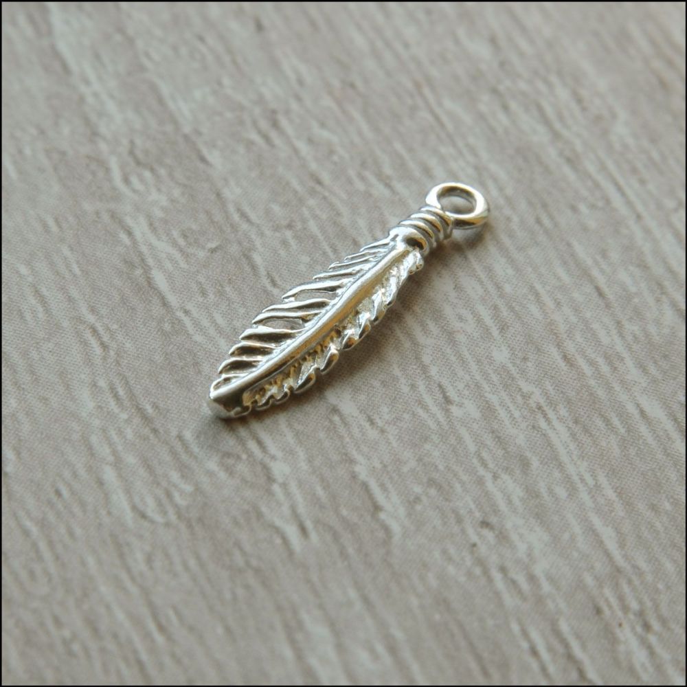 Sterling silver charm in the shape of a feather
