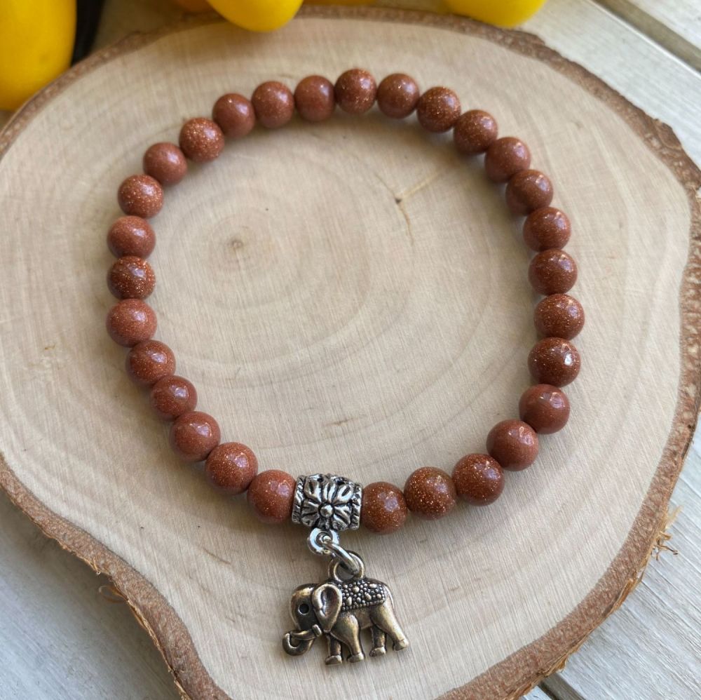 Crystal Bracelet with Goldstone Beads and a Elephant Charm