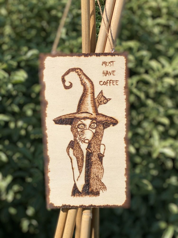 A Pyrographed Wooden Hanging Board with a Witch and 