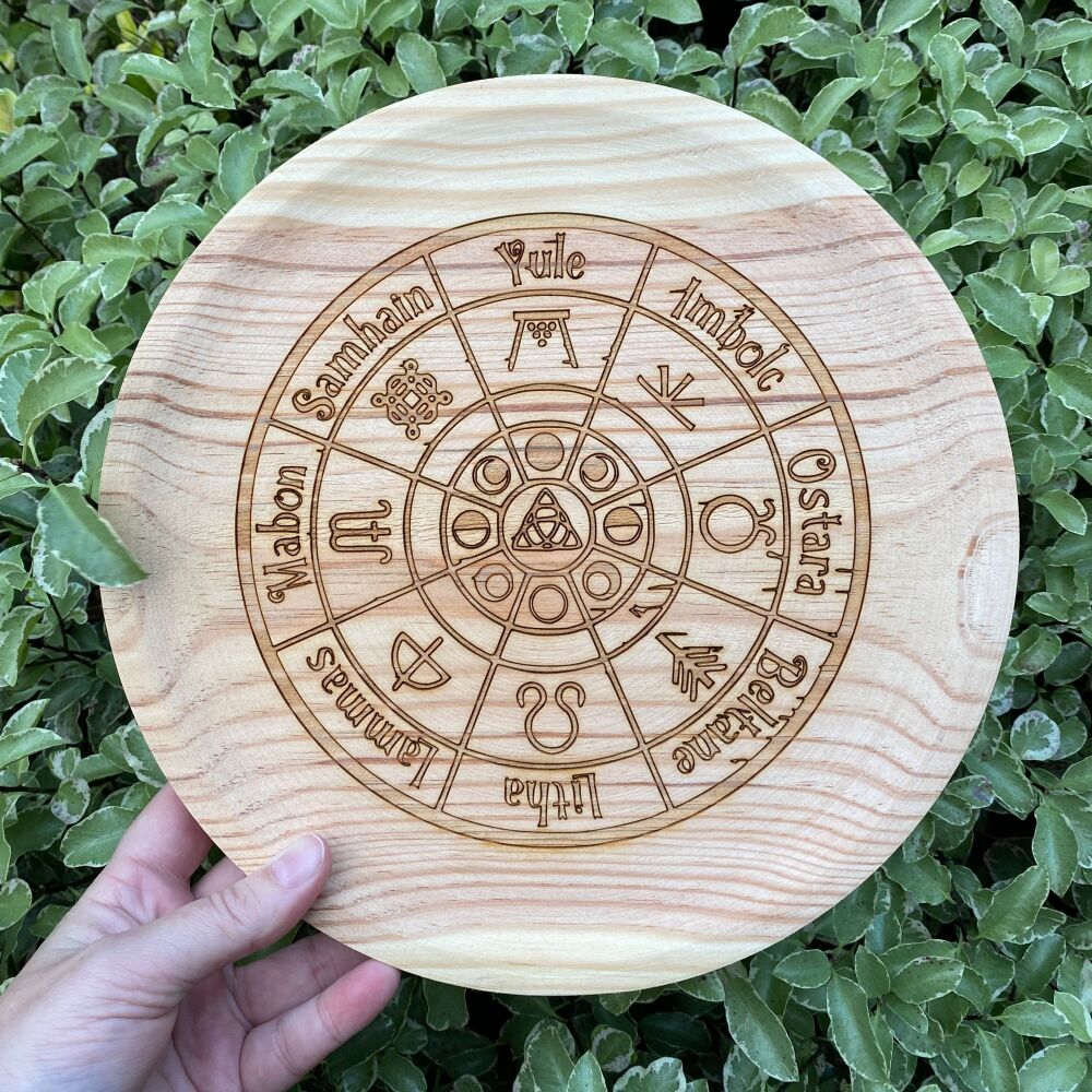 A Large Rustic Wooden Spell Casting Plate with Wheel of the Year design