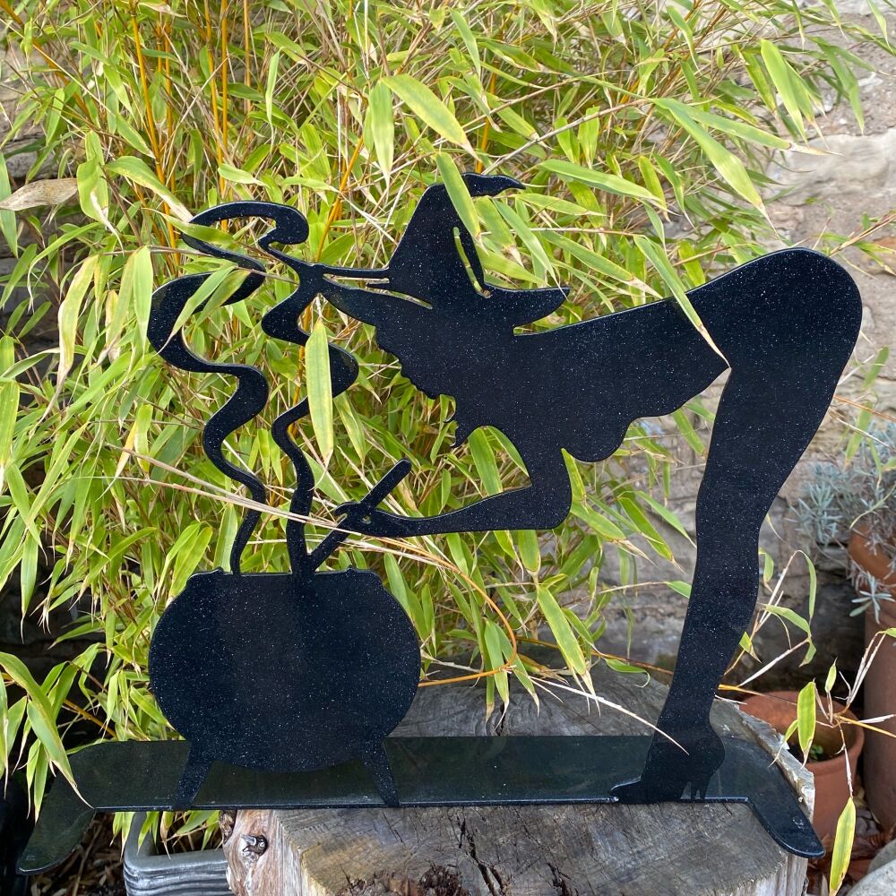 A lovely Hand Made Metal Witch Stirring her Cauldron