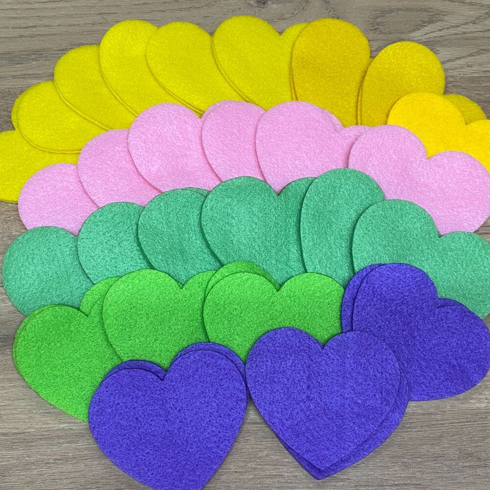 A collection of around 27 pairs of cut out felt hearts