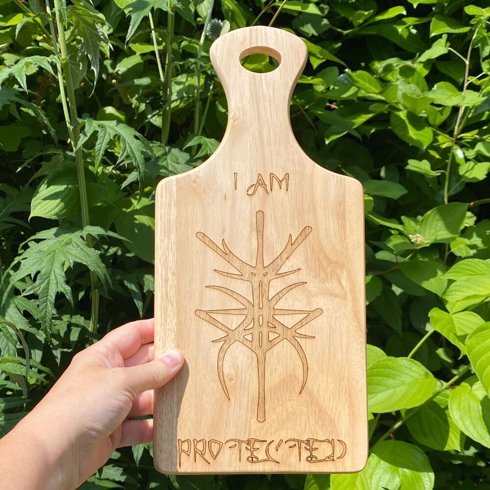 A Handcrafted Wooden Paddle Board with "I am Protected" Bind Rune design