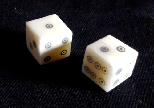 Two ring-and-dot style bone dice from The Historic Games Shop