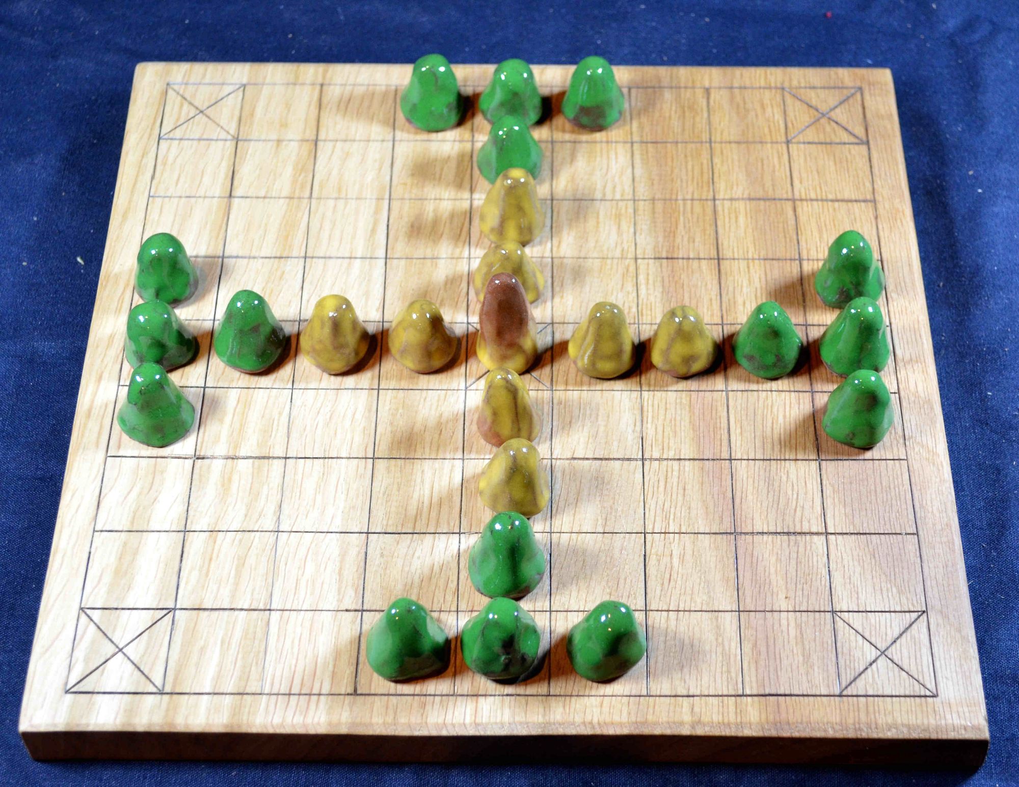 9 x 9 tafl board of oak, with glazed ceramic playing pieces