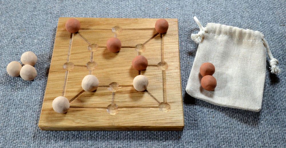 Six Men's Morris, oak board with ceramic playing pieces and linen pouch