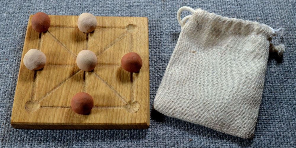 Three Men’s Morris with ceramic pieces in a linen pouch