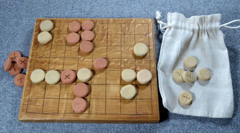Ludus Latrunculorum board of 8 x 7 squares, with ceramic playing pieces
