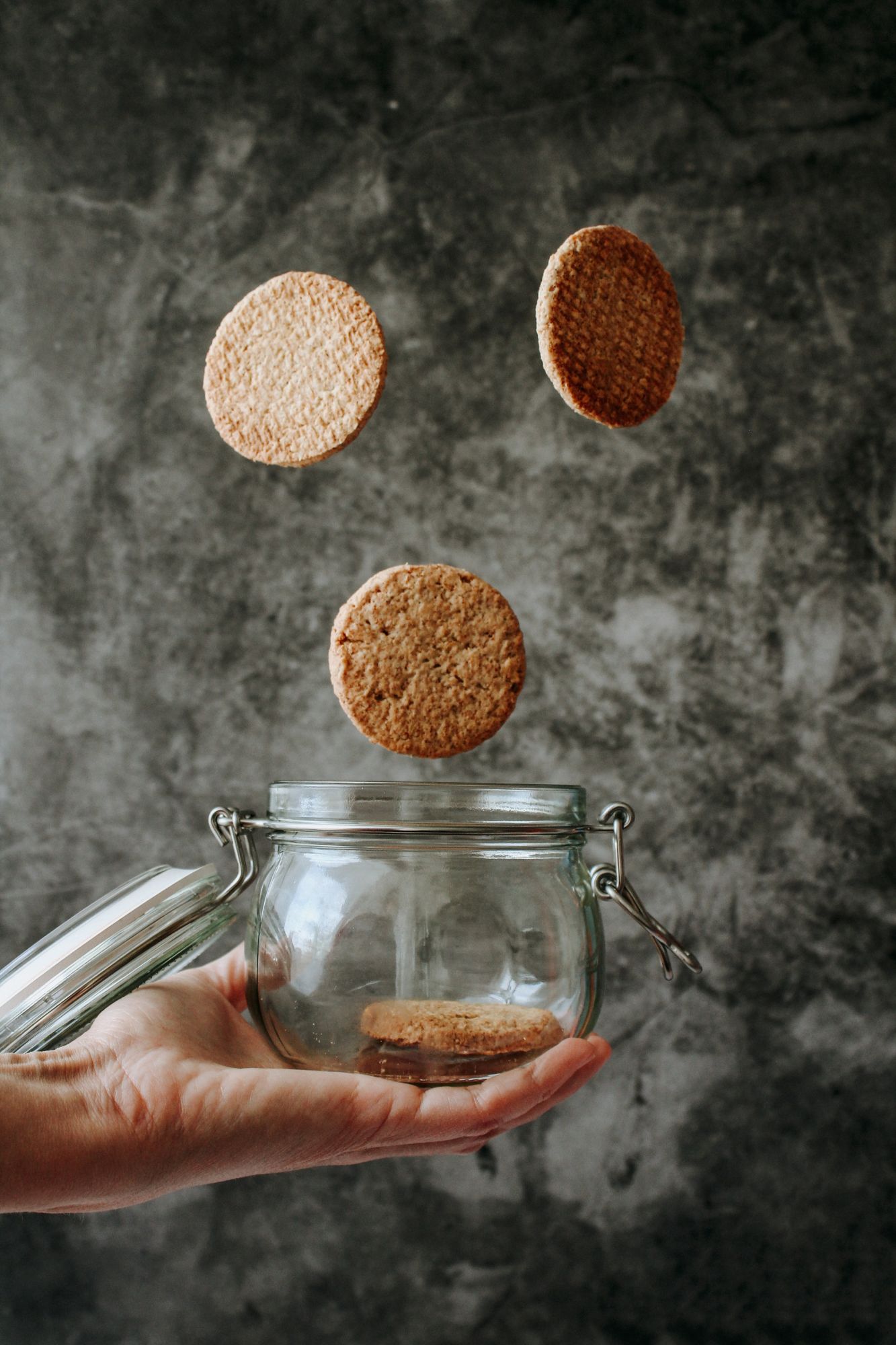 Cookies dropping into a Mason Jar