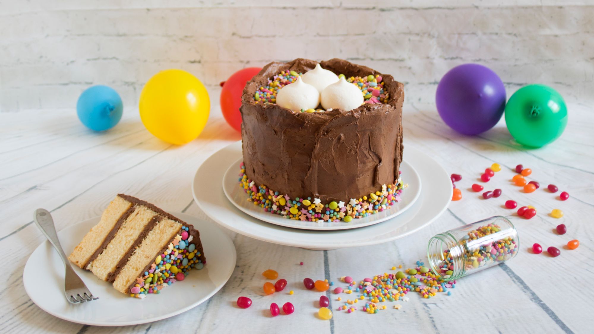 Vanilla Chocolate Cake with sprinkles and meringue decorations