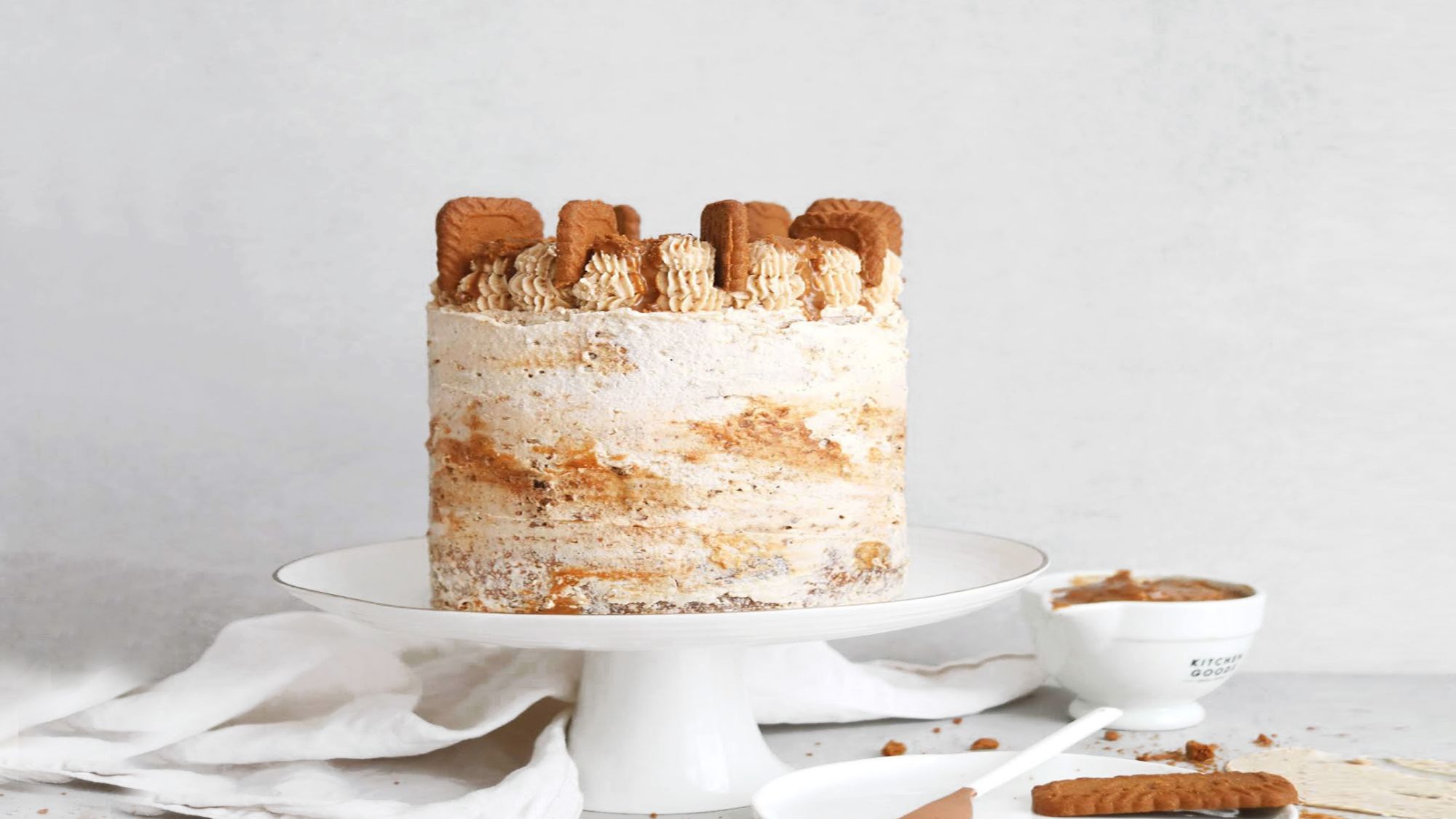 Biscoff Cake with simple piped decorations and cookies