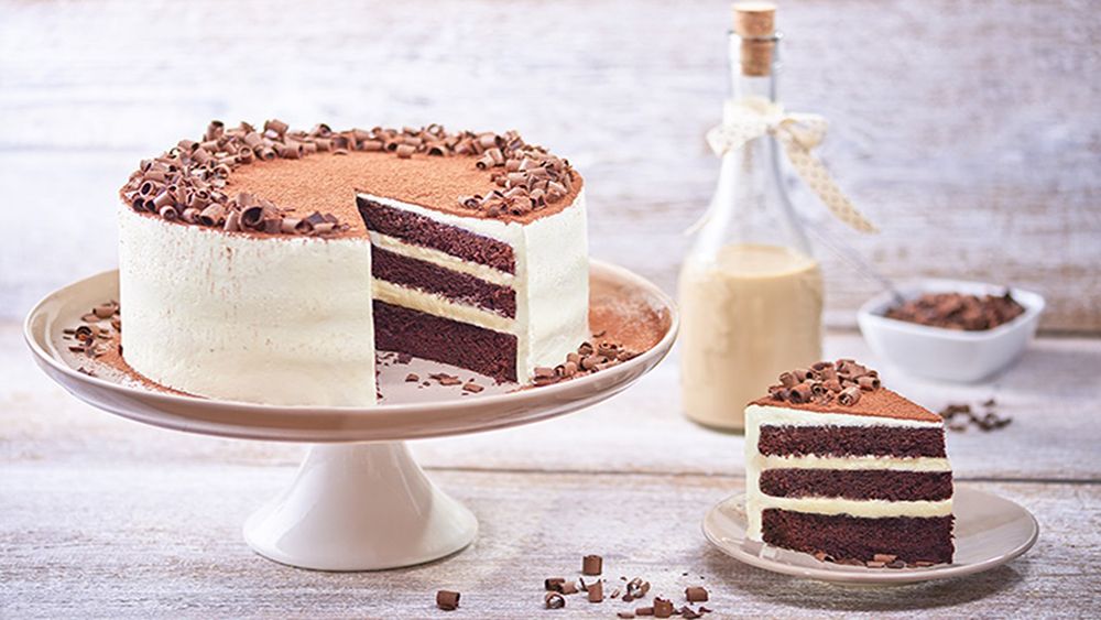 Biscoff Cake with simple piped decorations and cookies