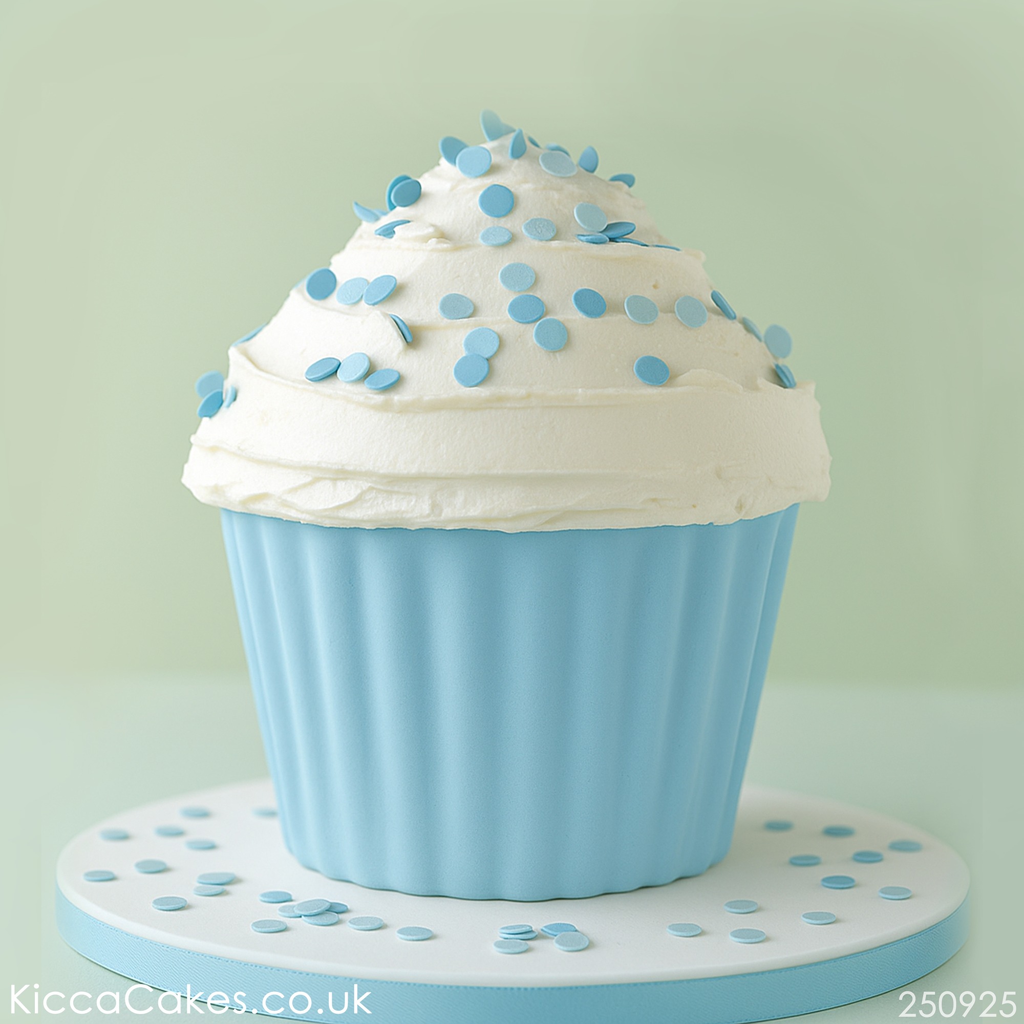 Giant cupcake for boy decorated with blue sugar confetti.