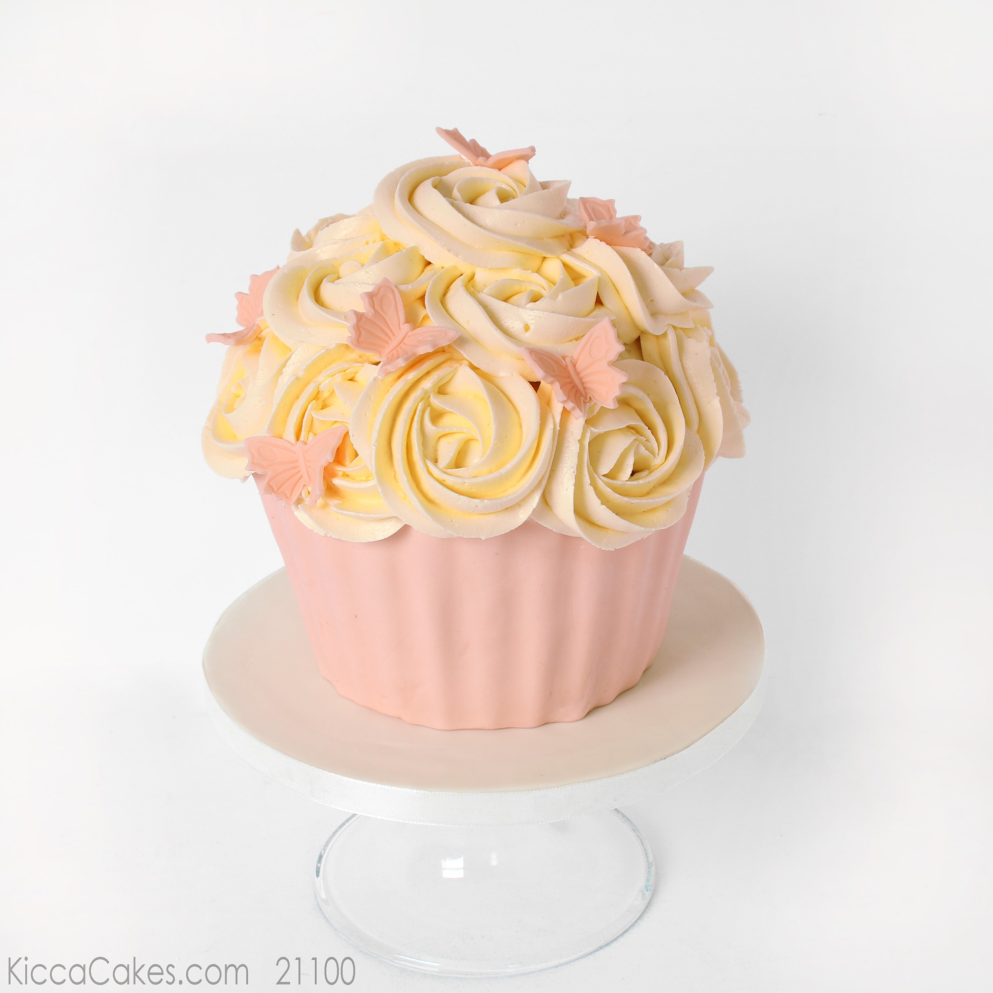 Giant cupcake with pink sugar butterflies.