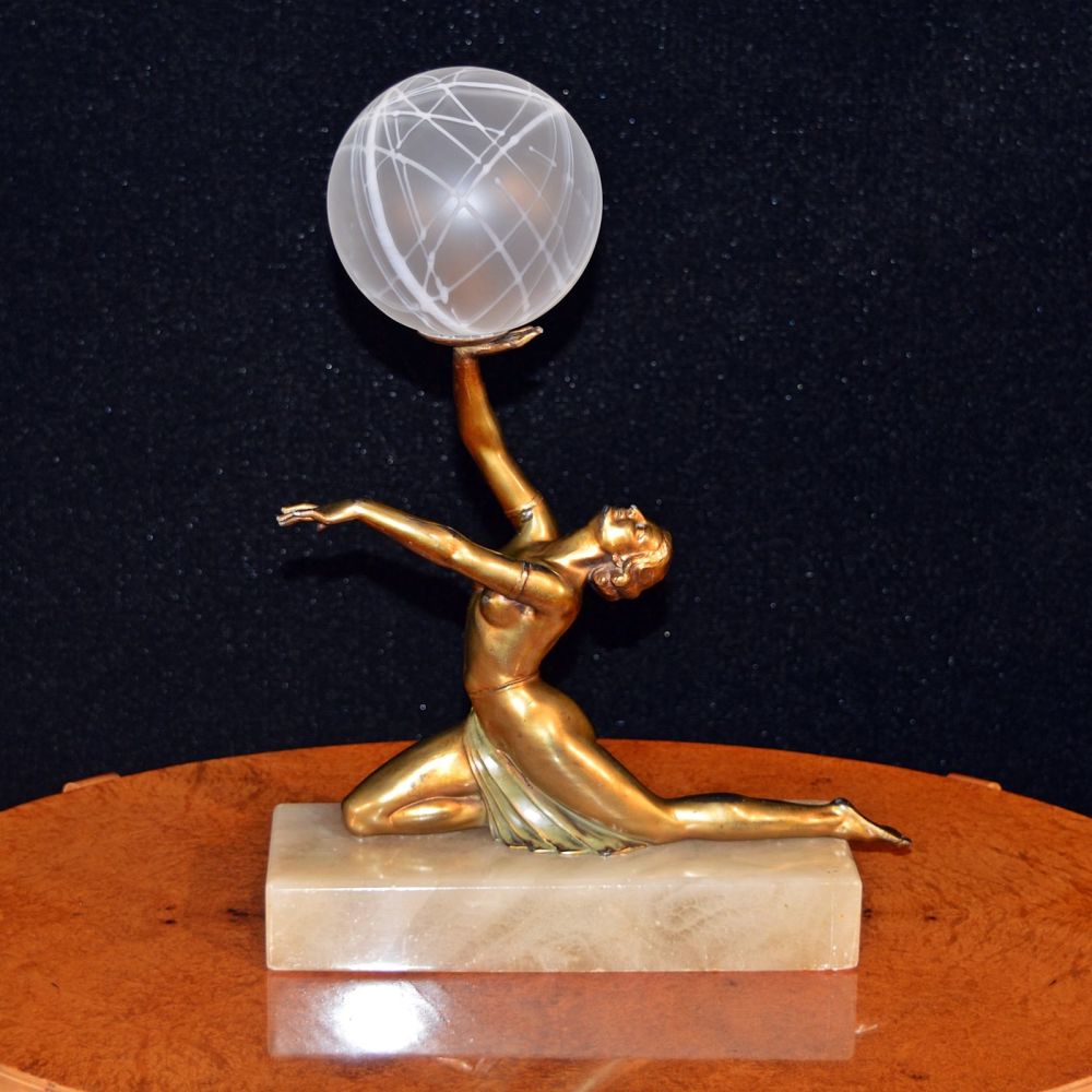 Art Deco lamp modelled as a semi-clad lady holding aloft a globe