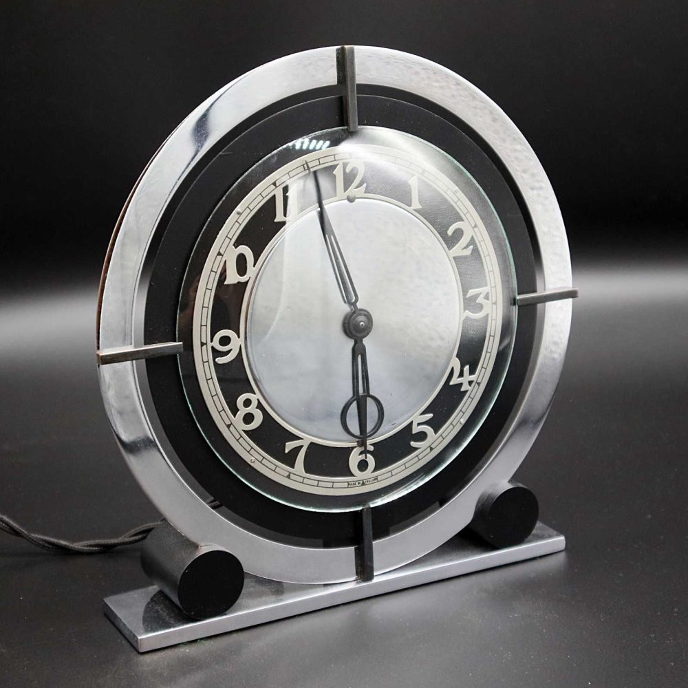 A good Art Deco chrome and bakelite electric clock by Temco.