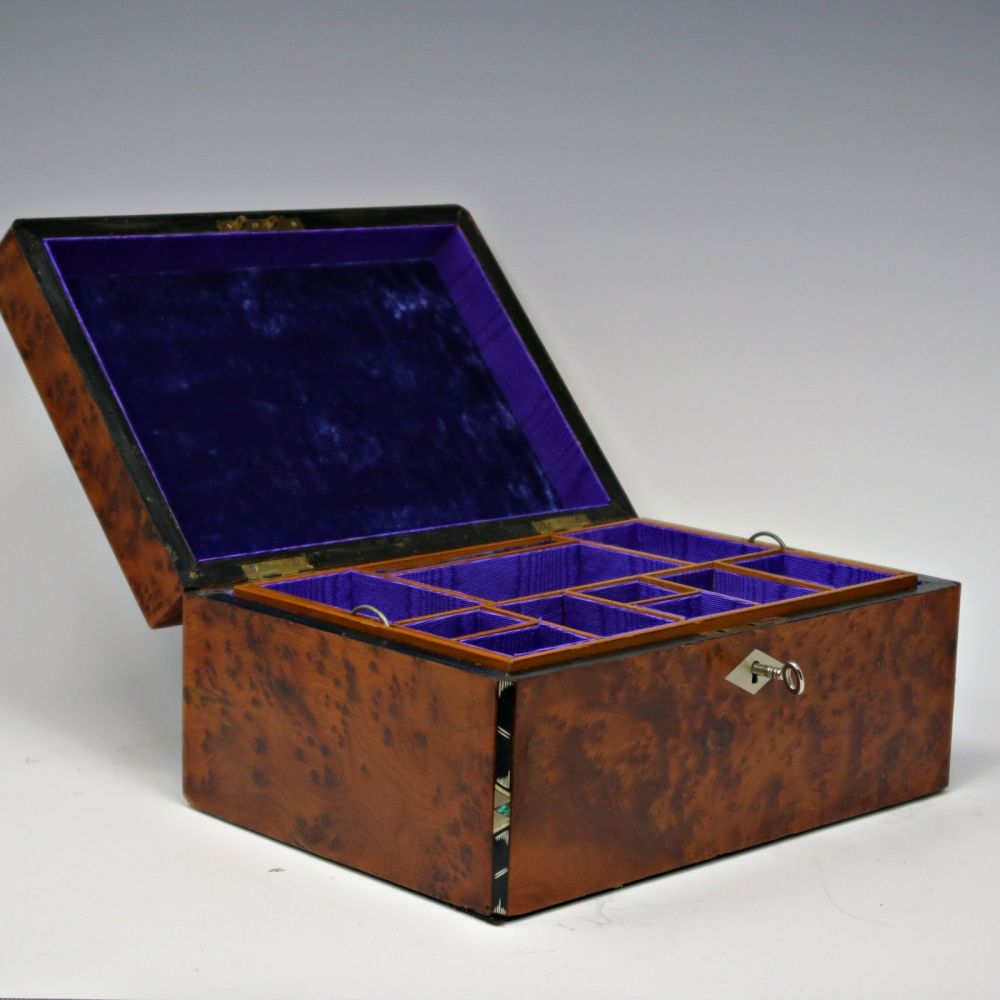 Antique amboyna and inlaid jewellery box.