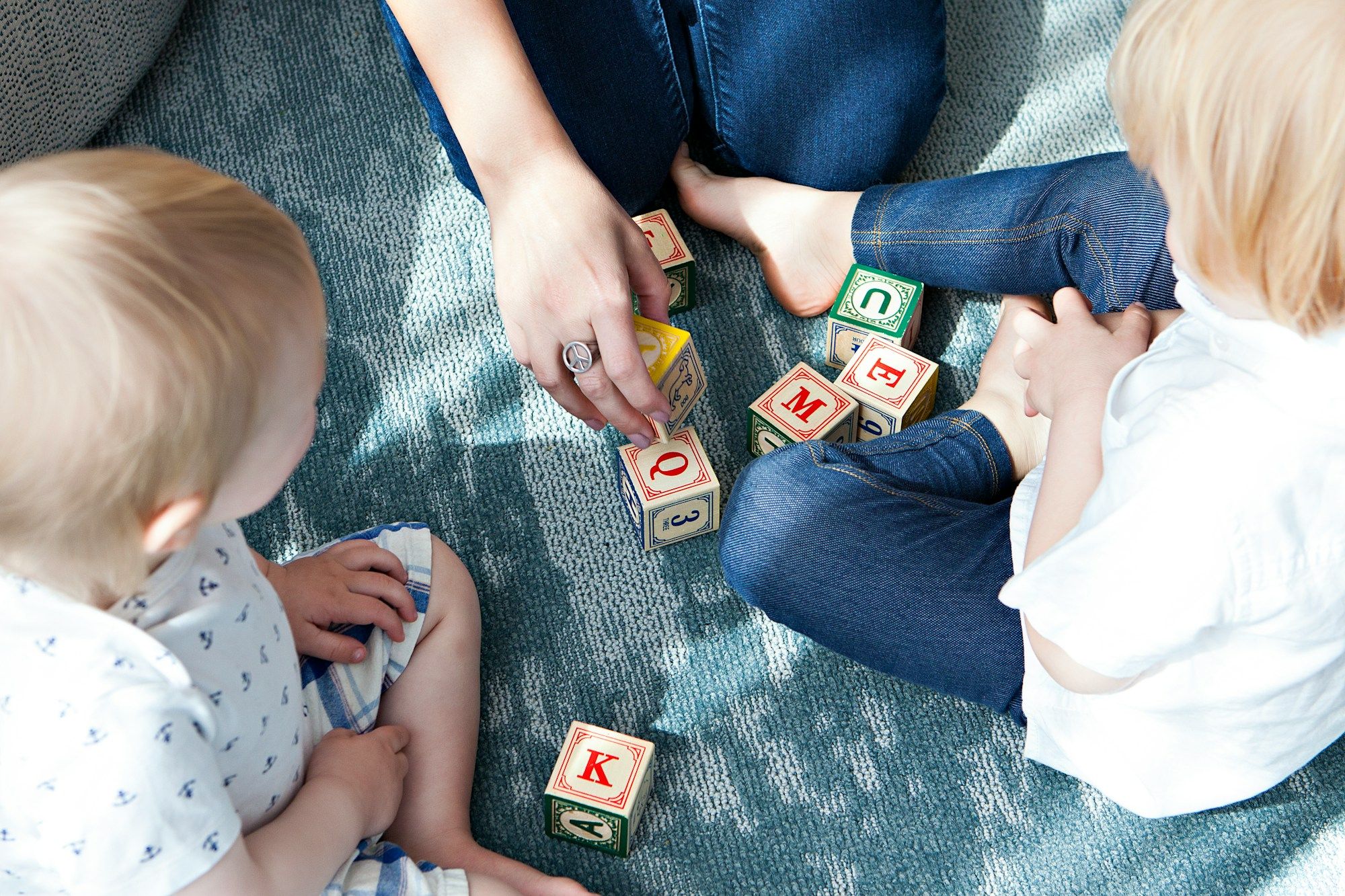 two-toddler-playing-letter-cubes-Cq9slNxV8YU