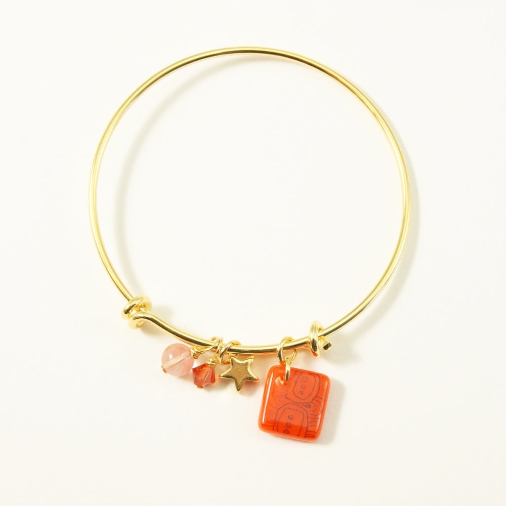 Orange neo bangle on gold