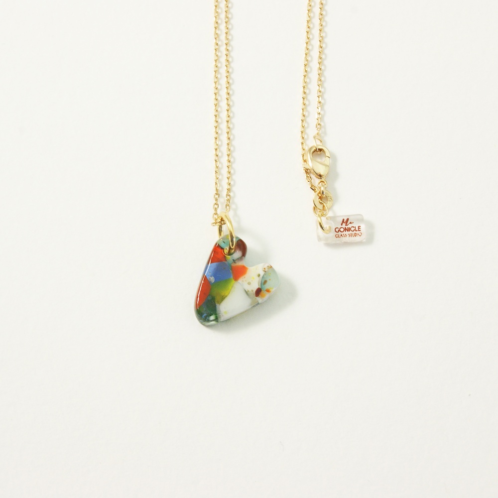 Multicoloured glass heart on gold