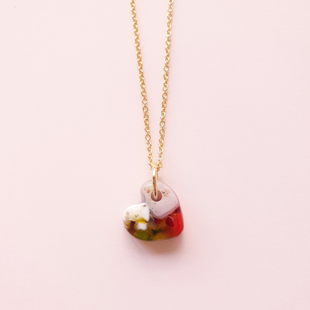 Multicoloured glass heart on gold