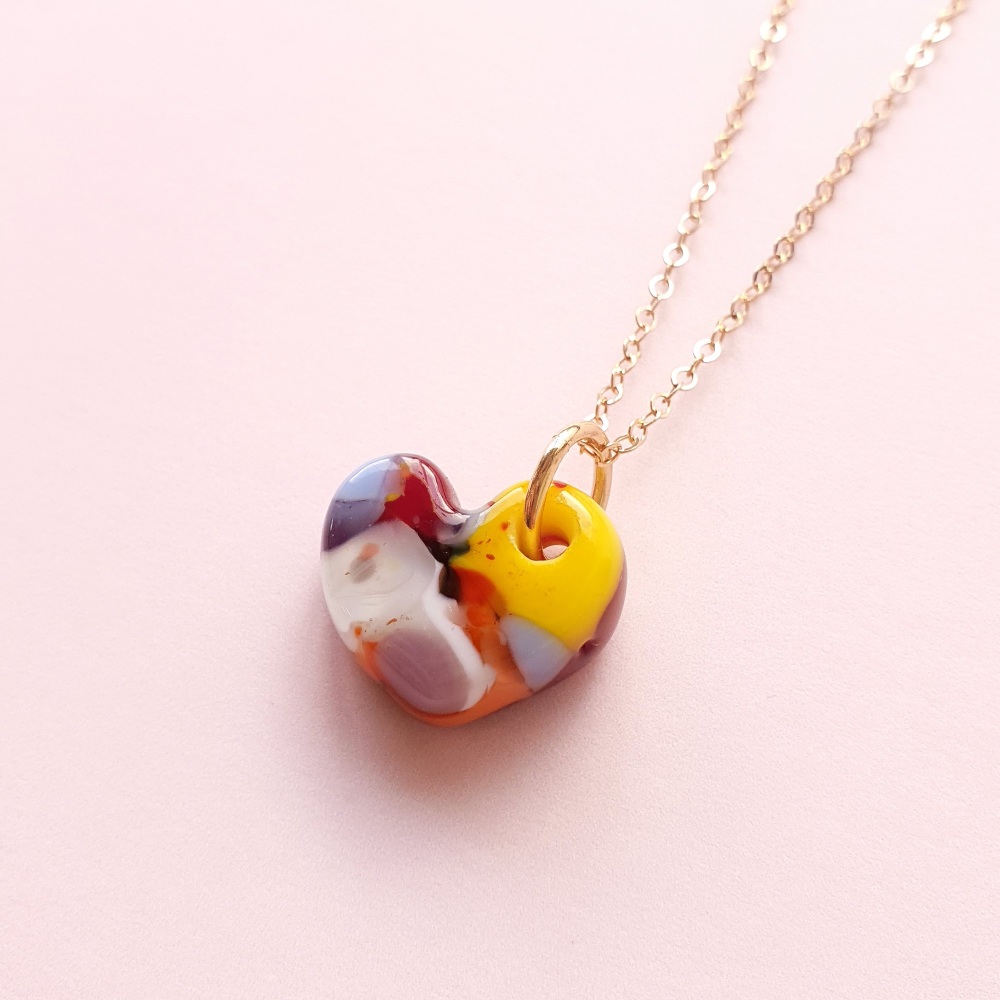 Multicoloured glass heart on gold