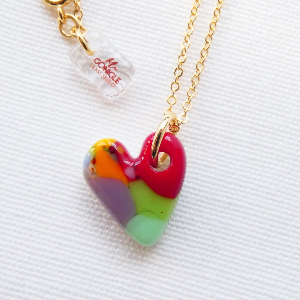 Multicoloured glass heart on gold