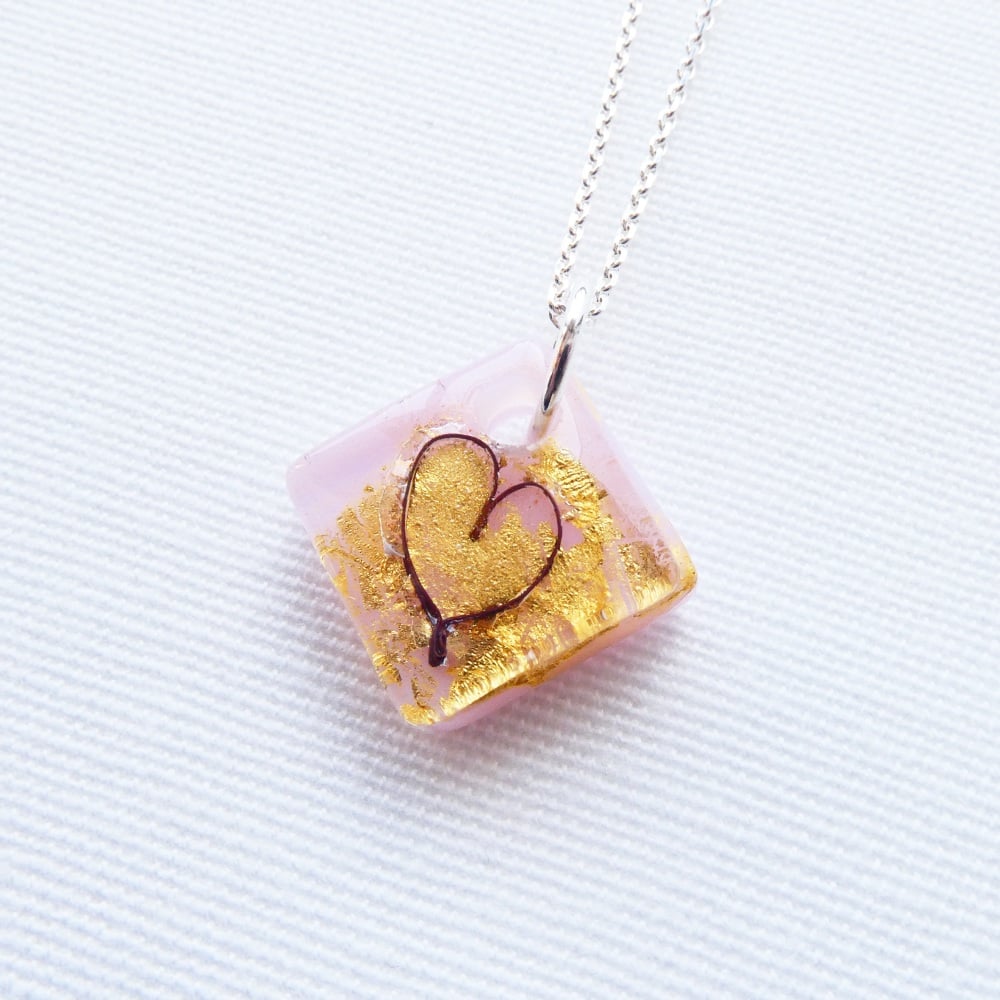Small fused heart in pink glass on an 18 inch solid sterling silver chain.