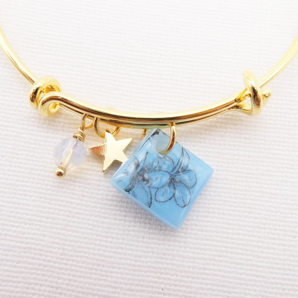 Blue floral drawing Glass Tile On a 14K Gold Plated Bangle