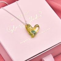 Green glass heart on silver