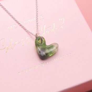 Green glass heart on silver