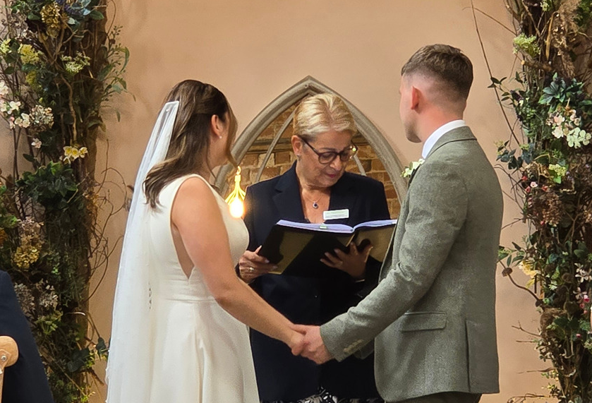 Bride and groom in back of wedding car at Oddhouse Farm