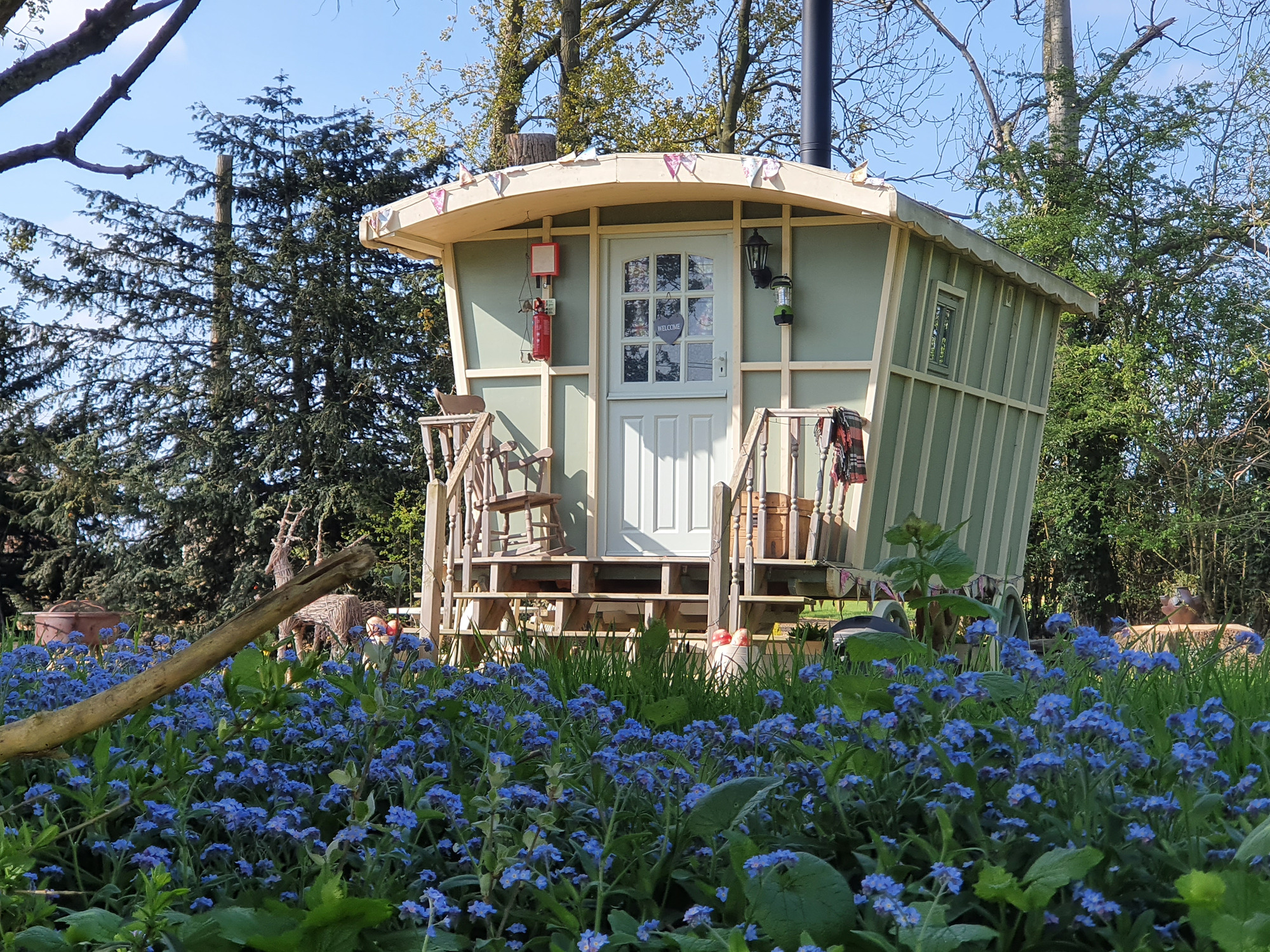 BRide and groom on the steps of the gypsy caravan