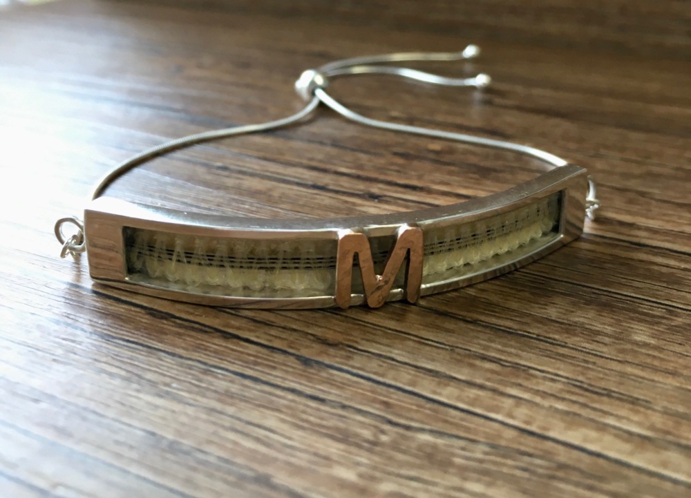 Friendship bracelet with horsehair braid and bronze initial.