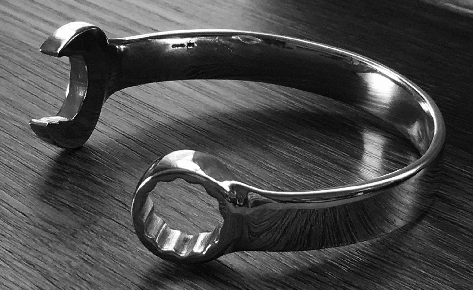 A mans sterling silver cuff bracelet in the shape of a spanner