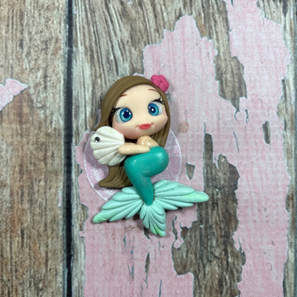 Mermaid with pink flower and white seashell