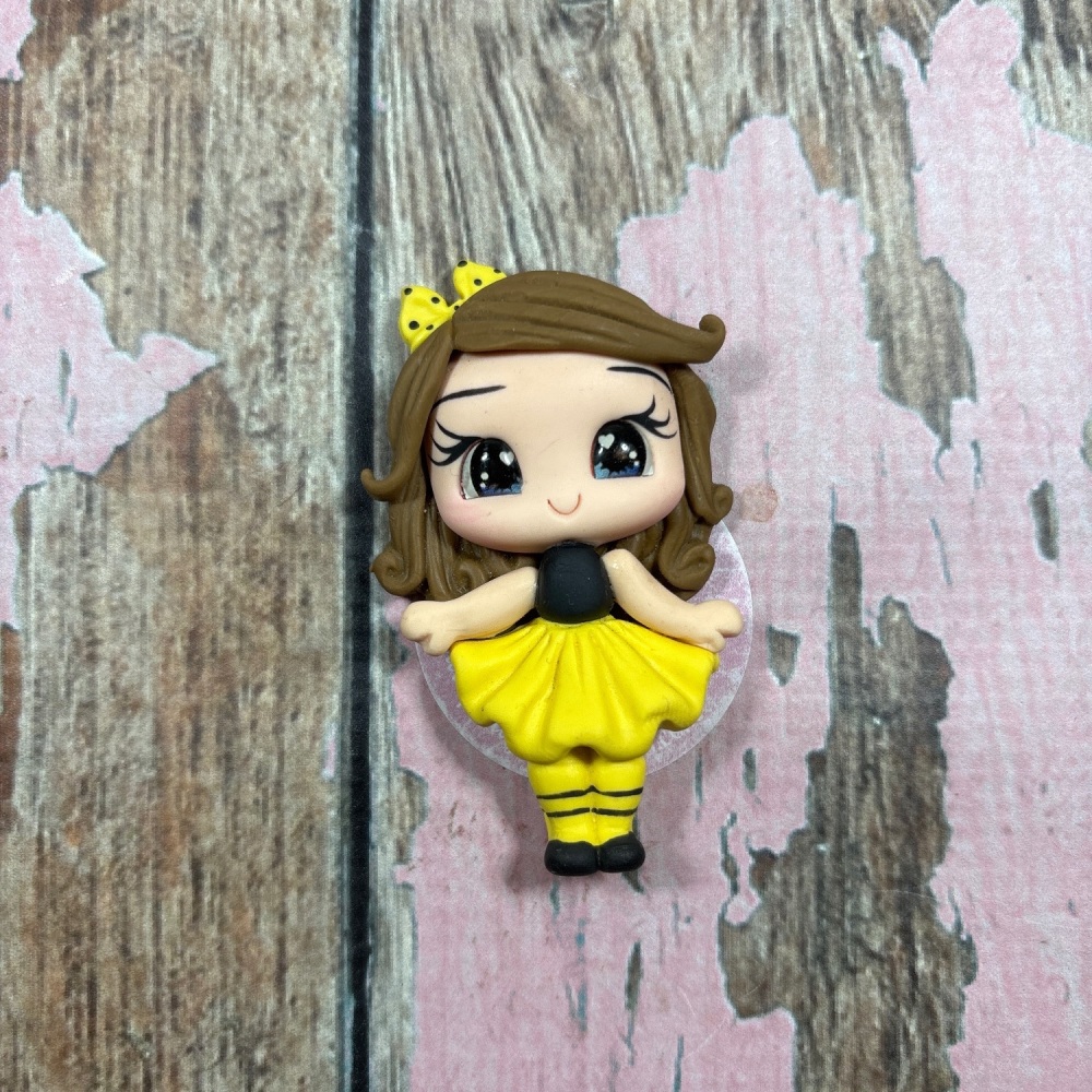 Black and yellow stripes with yellow polkadot bow blue eyes