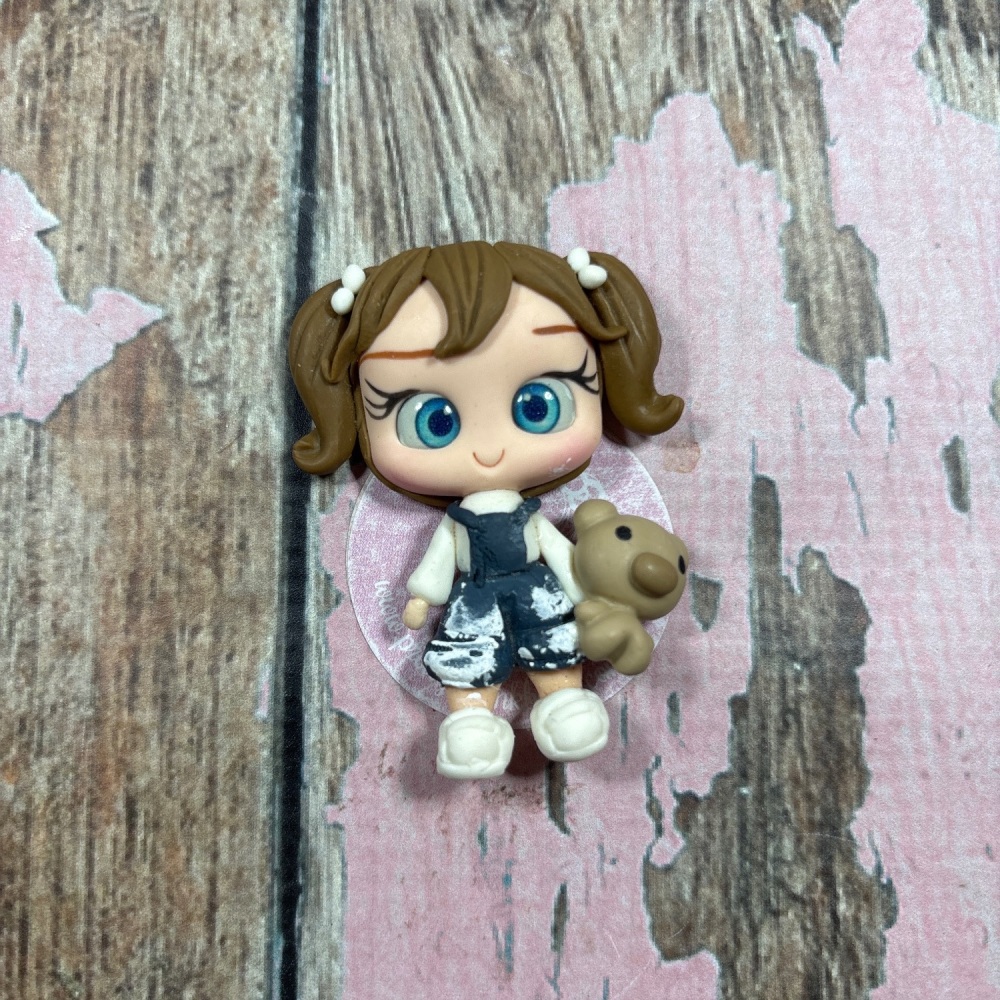 Little girl blue dungarees with paint splatter and teddy bear brown hair blue eyes