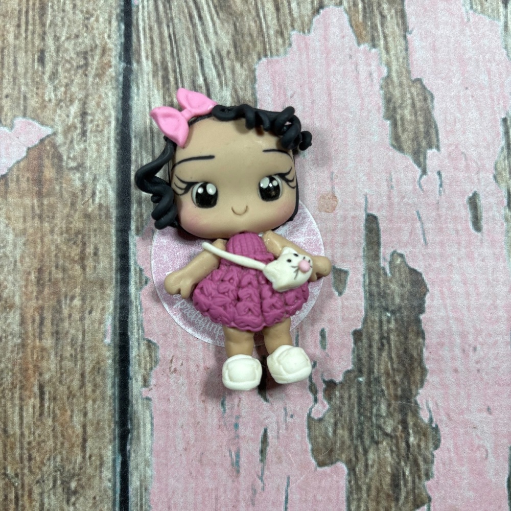 Little girl, purple dress, pink bow with Kat handbag