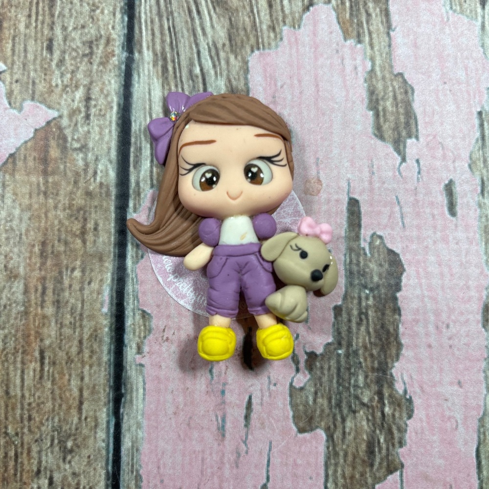 Little girl in lilac tracksuit with puppy dog in pink Bow