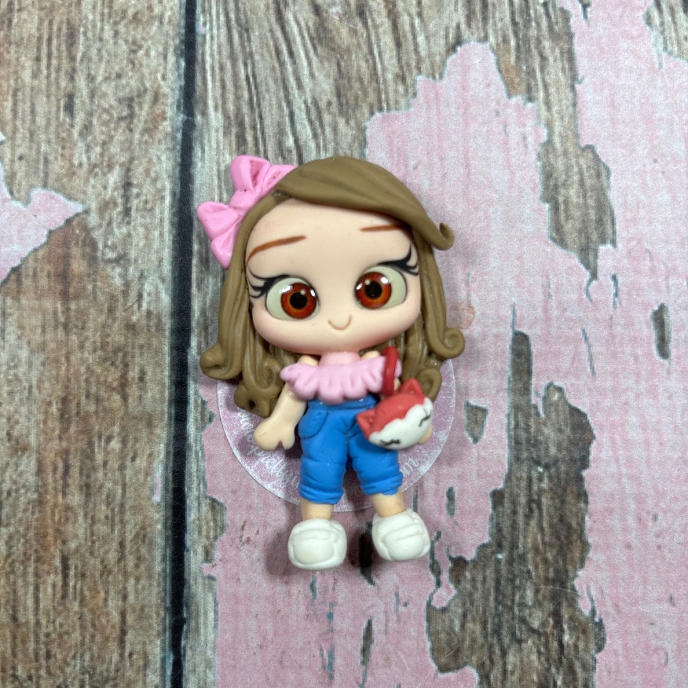 Little girl in blue jeans, pink ruffle top fox bag, light brown hair, brown eyes