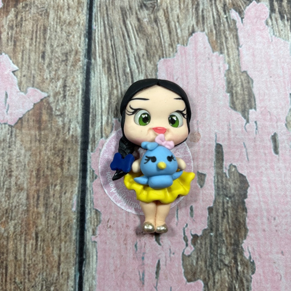 Little girl, yellow dress, blue bird blue bow, black hair, green eyes