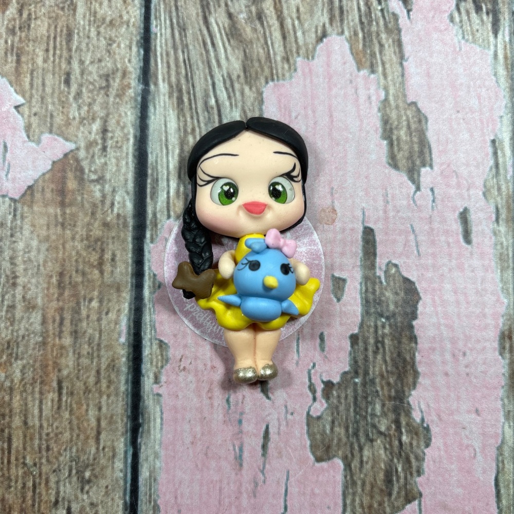 Little girl, yellow dress, blue bird brown bow, black hair, green eyes