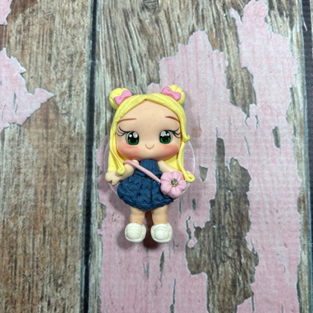 Little girl, blue denim dress, pink flower bag, blonde hair, pink bows, green eyes