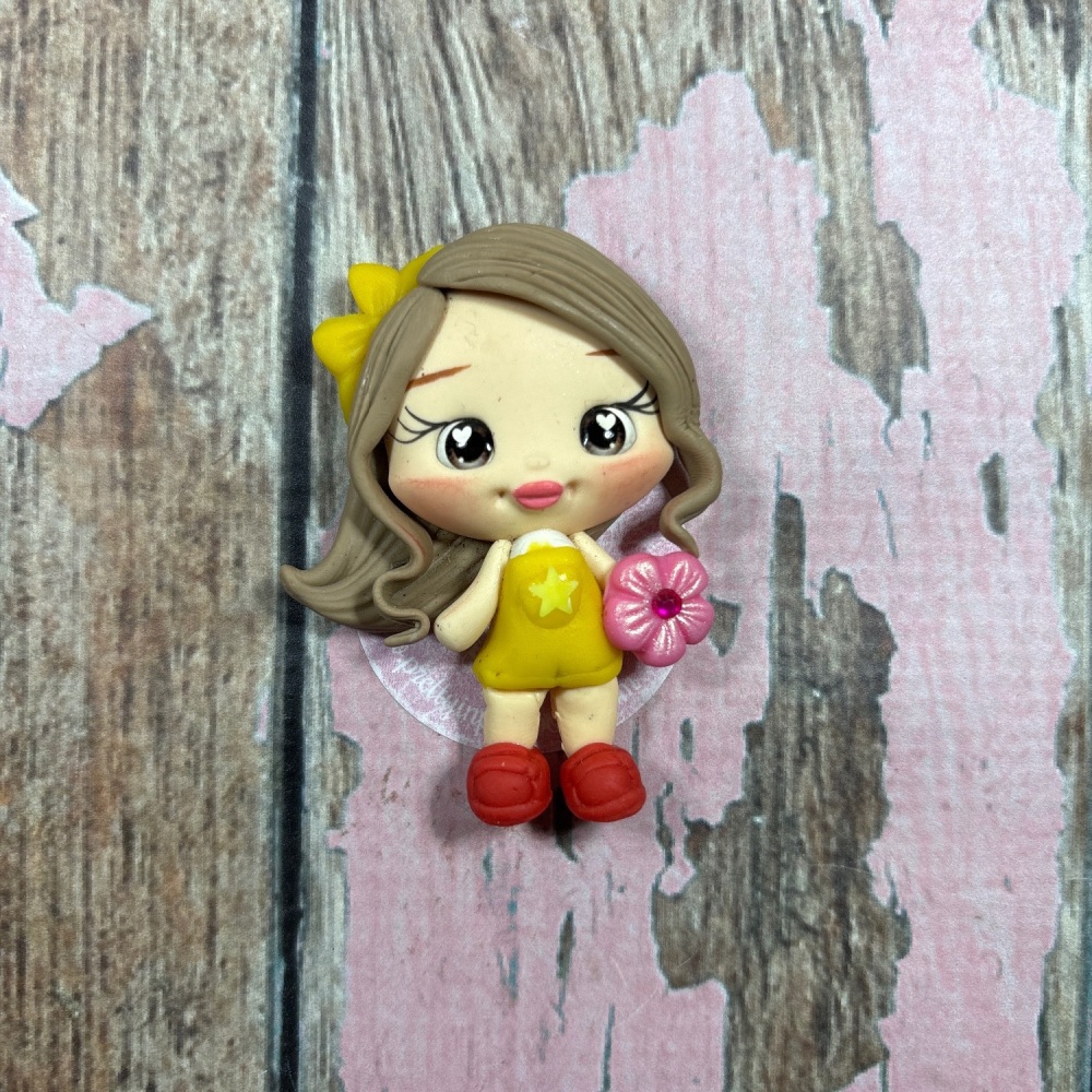 Little girl, yellow dungarees, pink flower, yellow bow in hair light brown hair, grey eyes