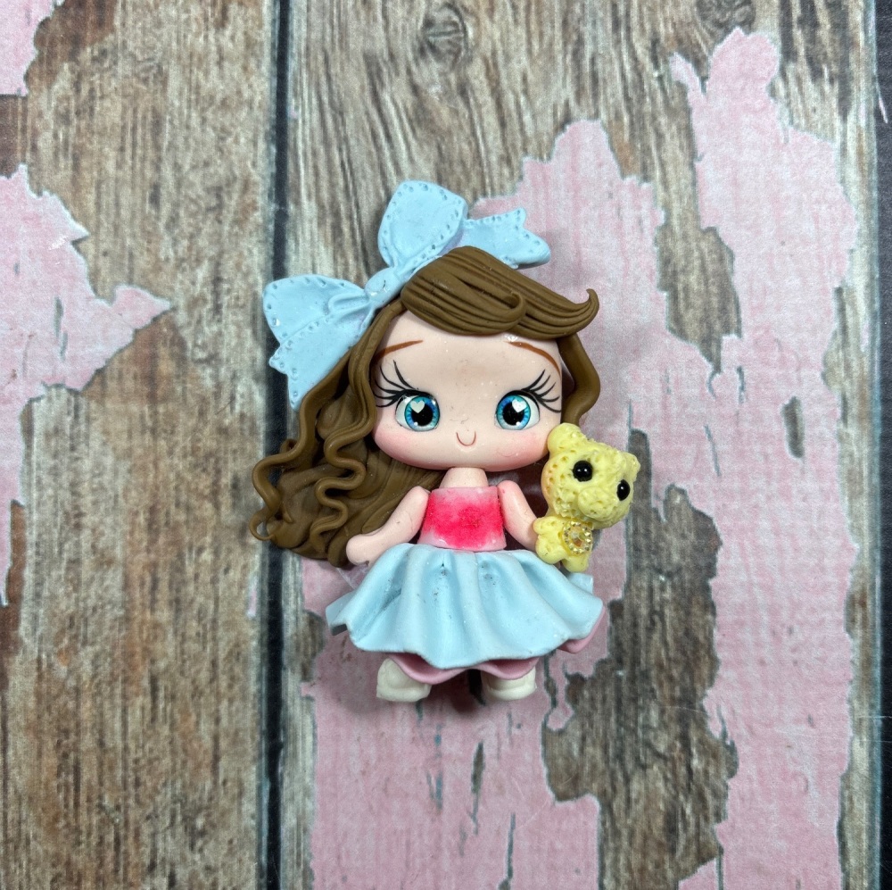 Little girl, layered pink and blue dress, big blue bow with teddy bear brown hair blue eyes